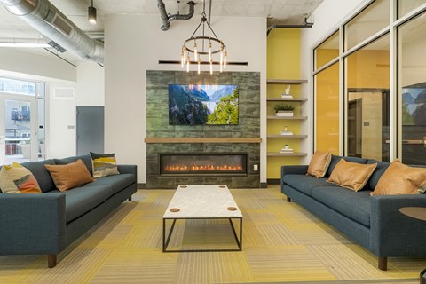 A modern living room with a fireplace and a television mounted above it.